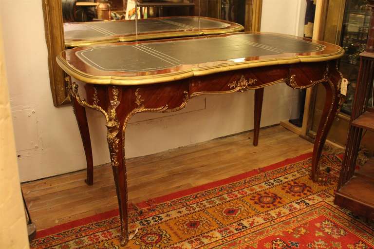 Bureau plat with leather top, bronze ormolu mounts and one drawer. This can be seen at our 149 Madison Ave store in Manhattan.