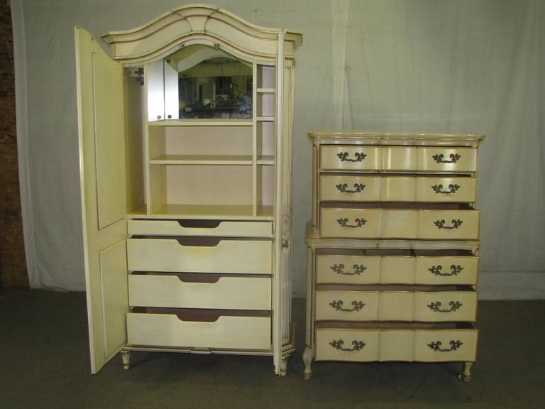 This set of vintage armoire and highboy furniture both have brass handles in cream with gold trim. This item can be seen at our National Warehouse at 400 Gilligan St., Scranton, PA.