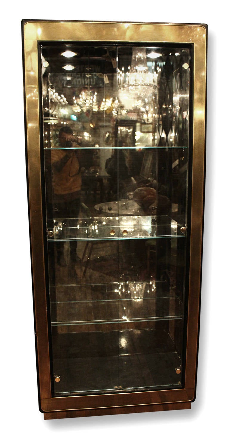 Very good condition. Mid-Century Modern Mastercraft display cabinets with recessed lights and glass shelves. Priced as a pair. This item can be seen at our 149 Madison Avenue store at 32nd St in Manhattan.