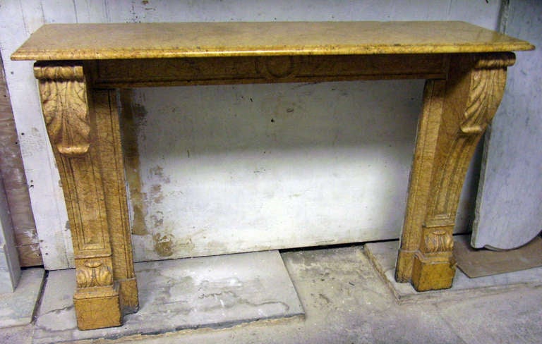 This 1890s petite yellow marble mantel was recently removed from a home on East 75th Street in Manhattan. The overall condition is good: There is a piece of marble missing from the plinth block. Possibly the mantel was originally taller and was