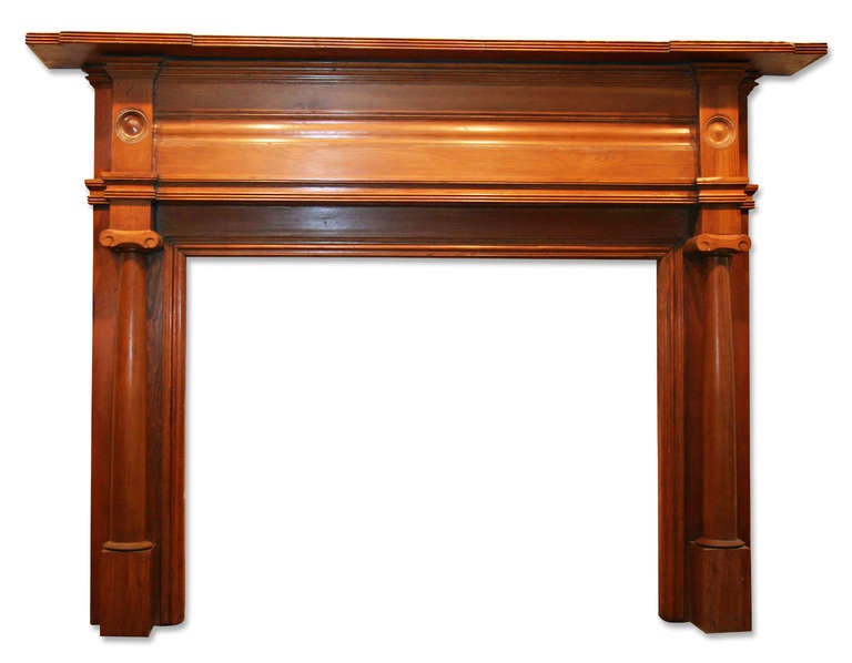 Full columns dress the jambs of this early American Federal style mantel. It has tablets on both sides below the curved shelf with projections on both sides. Bullseye detail on sides, very heavy. This is one of several additions from Danny
