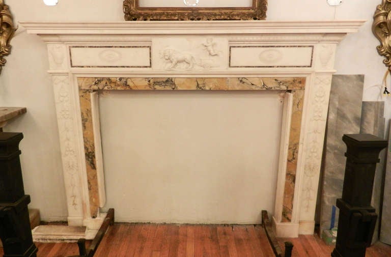 Original antique Georgian mantel with a Sienna inlay. Nicely carved details of a cherub and chariot. This item can be seen at our 149 Madison Avenue location in Manhattan.
