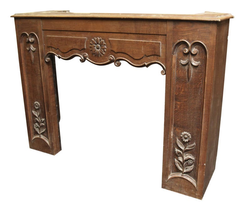 Wooden carved chimney mantel with floral detailing. This can be viewed at our Scranton, Pennsylvania location. Please inquire for the exact address.