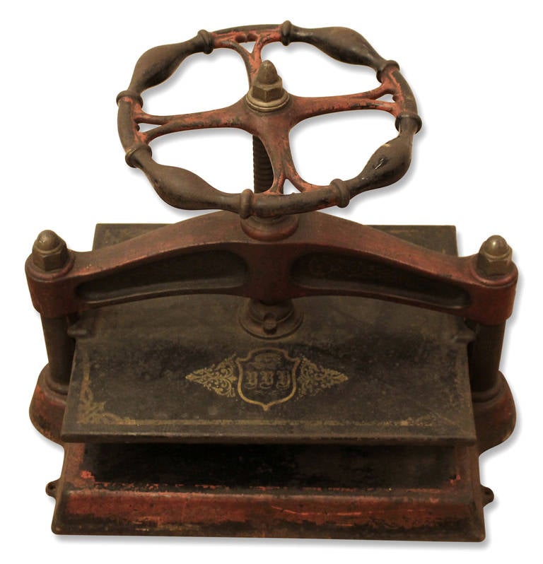 1850s Victorian red book press with ornate wheel. This can be seen at our 149 Madison Ave location in Manhattan.