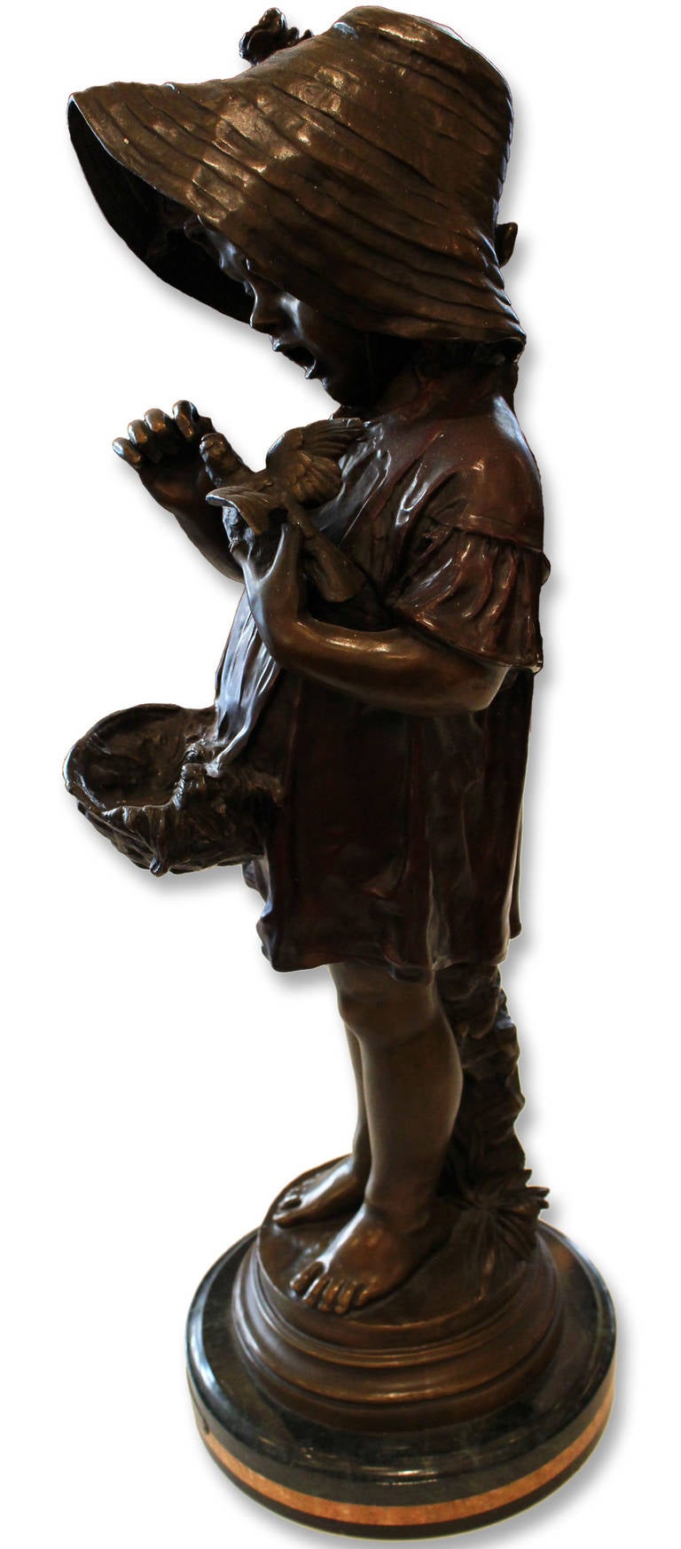 This is an adorable statue of a young girl holding a little bird. It will bring a smile to your face every time you look at it. This bronze statue by Fuenze with a green marble base, is handmade and cast in the traditional lost wax casting process.