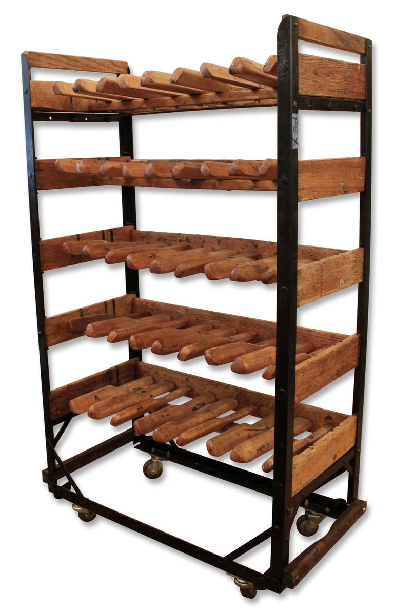 Antique wooden shoe rack from 1890 with vintage casters. Perfect wine rack great for kitchen. This item can be seen at our Madison Avenue location.