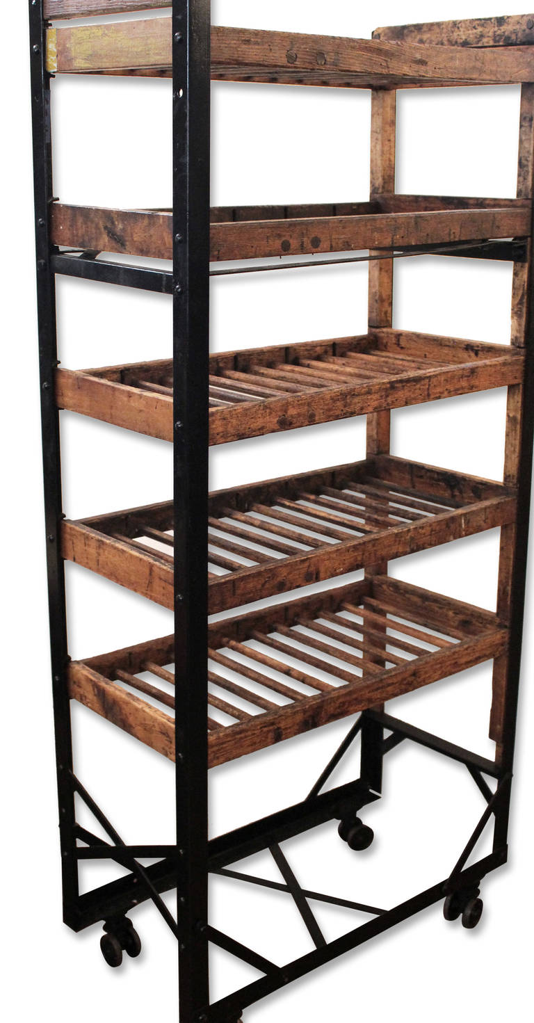 Antique narrow wooden shoe rack from late 1800's with vintage casters. Perfect wine rack great for kitchen.  Also used for hanging of kitchen linens in some areas of Canada. This item can be seen at our 149 Madison Avenue location in Manhattan.