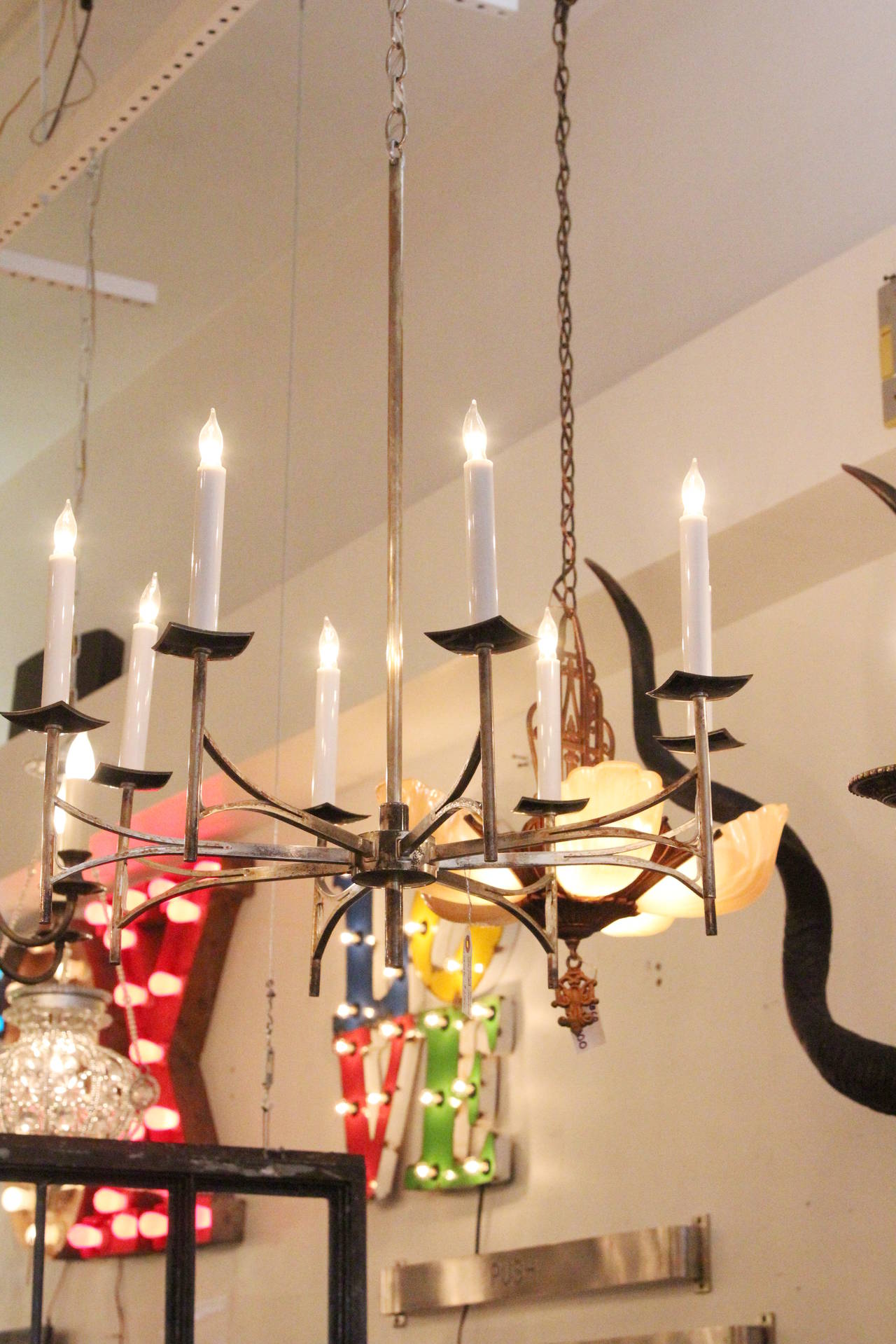 Mid-Century Modern silver plated French chandelier with eight arms from the 1950s. Chain and canopy are new. This item can be seen at our 302 Bowery location in Manhattan.