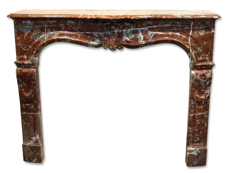 19th century Louis XV hand-carved mantel. This is a later example of Rouge Royale marble--a little redder than brown. Nicely done and a great size. This can be seen at our 400 Gilligan St, Scranton, PA location.