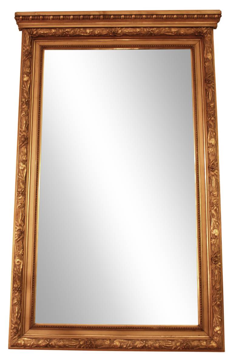 French carved wood, gold gilded mirror. The carvings include intricate lotus flowers and their leaves which is extremely rare. Includes original antiqued glass mirror. <br />
