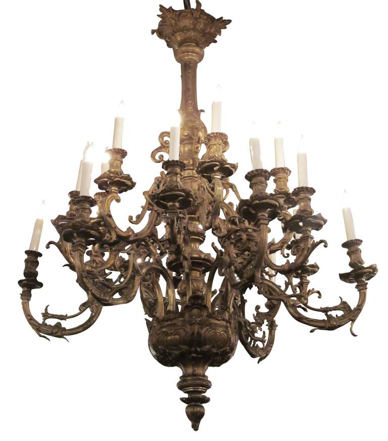 1930s grand scale French bronze chandelier with 18 lights. Antique rich patina - but can be brought to a high gilded sheen if desired. This can be seen at our 400 Gilligan St location in Scranton, PA.