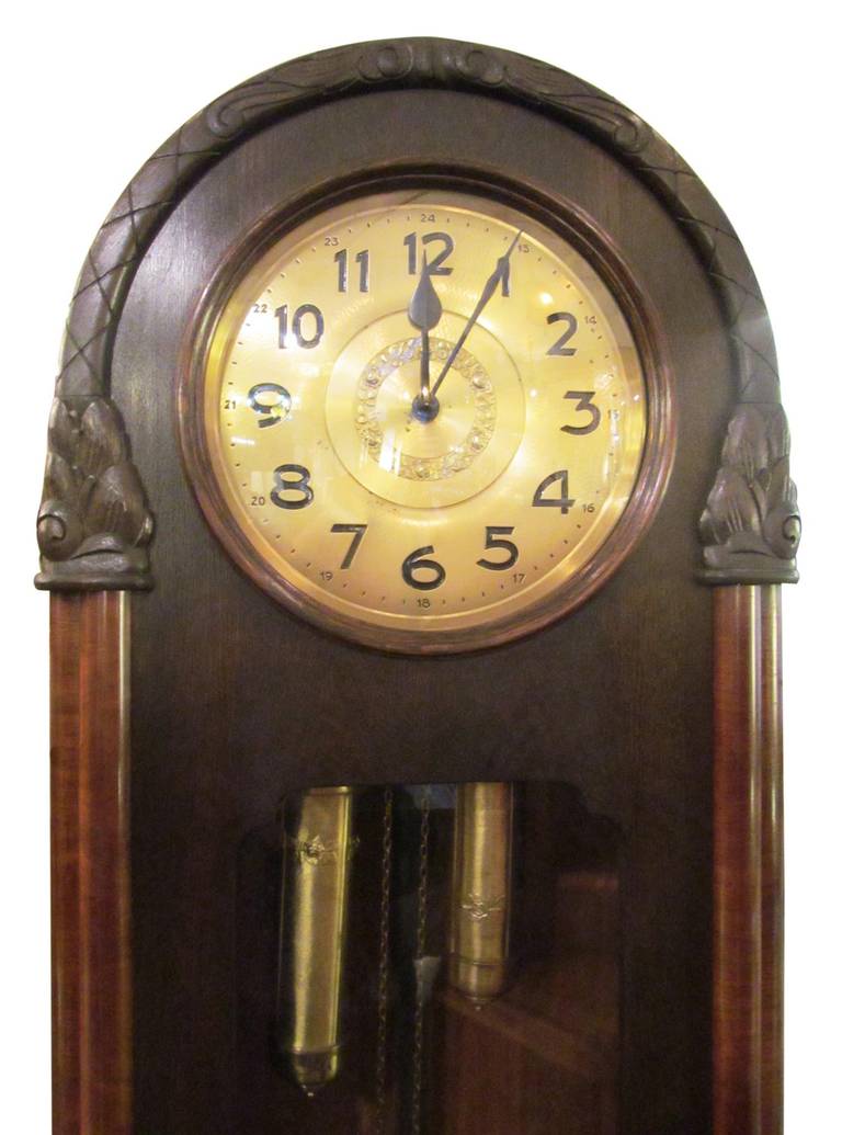 This is a beautiful hand-carved wood hall clock, from Wurzburg, Germany, circa 1890-1910. It has extra good German movements, time and strike, 8-day clock. Chimes each hour and strikes on the half hour. Unique hammered brass and roses on three