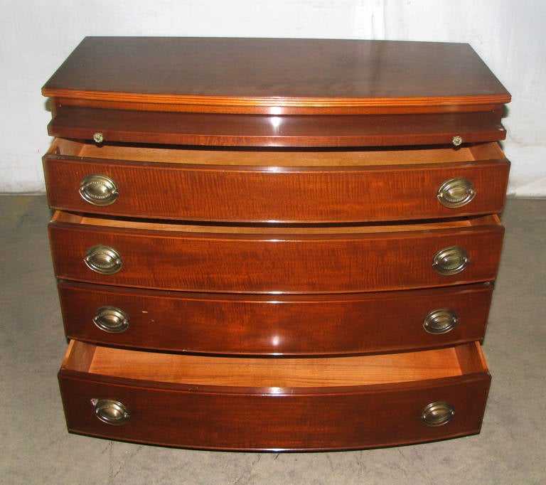 Antique curved front dresser has five drawers with oval Hepplewhite brass bail pulls. In excellent condition. This item is located at our 302 Bowery location in Manhattan.