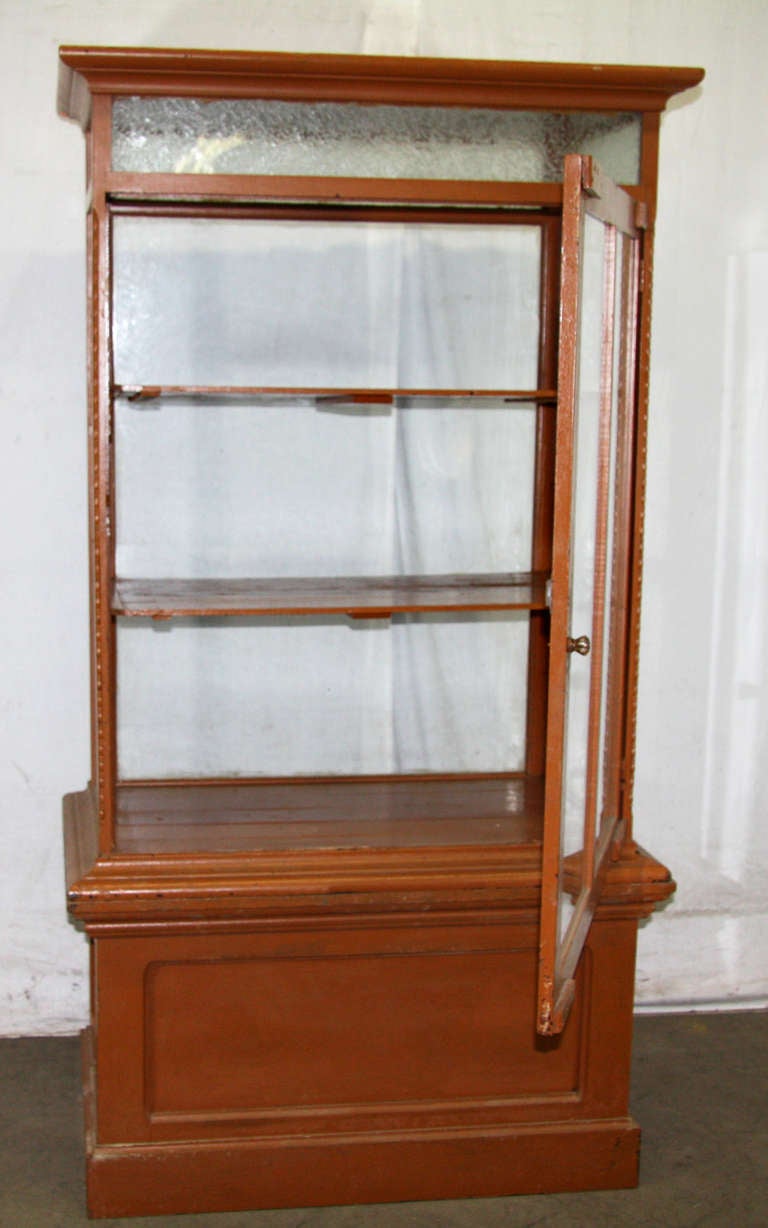 Early 20th century cabinet display with detailed molding throughout. Comes with two sturdy glass shelves. This can be seen at our 5 East 16th St location on Union Square in Manhattan.