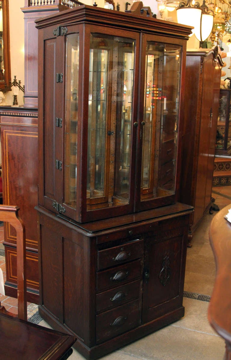 Remarkable dental cabinet made by W. D. Allison Company. This piece has three layers on the top, four drawers below, a door with a medical shelf, and a hidden side door. More pictures and details available upon request. This can be seen at our 5