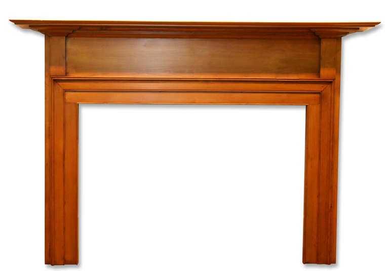 Very simple primitive American pine mantel with tapered shelf, raised molding around the firebox and slight corbels on the sides. There is no decoration on the frieze. This is one of several additions from Danny Alessandro & Edwin Jackson mantel