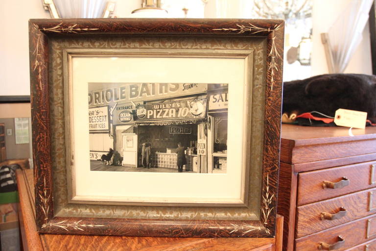 Original photo of Coney Island pizza stand. Newly matted and mounted in old frame. Back has transparent material showing George Daniell's signature on the back of the print. This can be seen at our 302 Bowery location in NoHo in Manhattan.