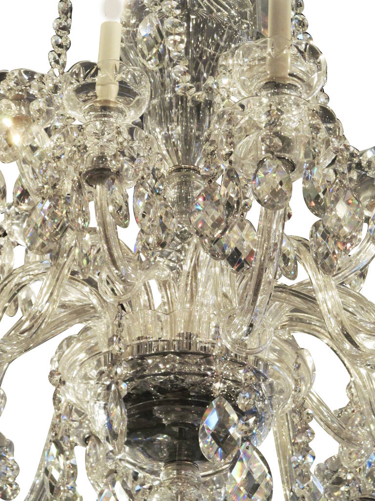 Beautiful 1960s Waterford Crystal chandelier done in a grand scale. There are 15 lights with the upper ring having elegant prisms. This lighting fixture has been carefully restored by hand and rewired in a manner that maintains the original