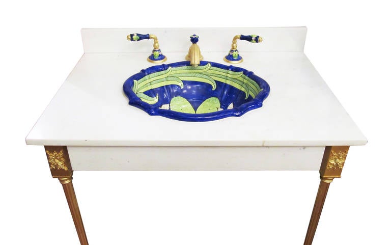 This sink is reclaimed from a high end residence in Manhattan. Hand-painted scalloped over edge basin with water lilies, mounted in a classic stone counter with two block top tapered counter legs. This item is located at our store at 149 Madison