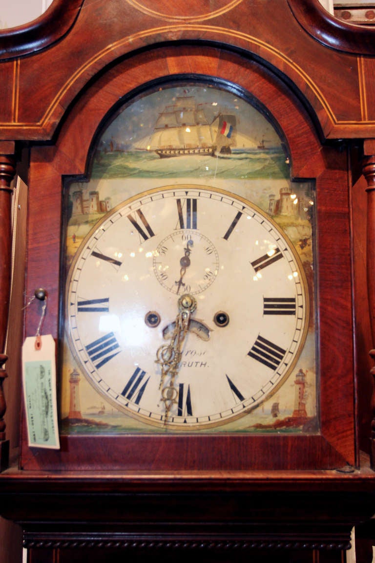 A beautiful antique grandfather case clock from 1820-1840 with mahogany inlay. All original including chimes, weights, and feet. Beautiful painted face with the writing on the dial reading 'Pembroke Renroth.' This can be viewed at our Scranton,