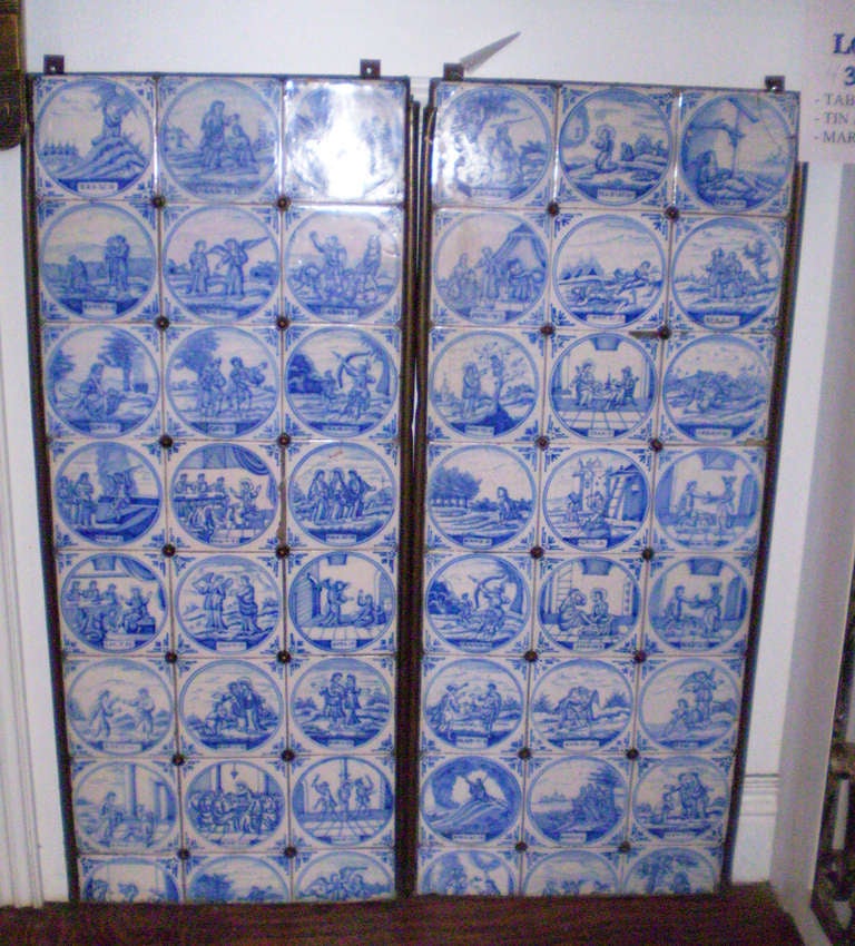 Two 1920s iron panels mounted with Delft tiles. Each tile shows a different Biblical scene with a corresponding verse underneath. Deft tile is made in Deft, Netherlands and is known for it's finer workmanship than other tile made in the Netherlands.