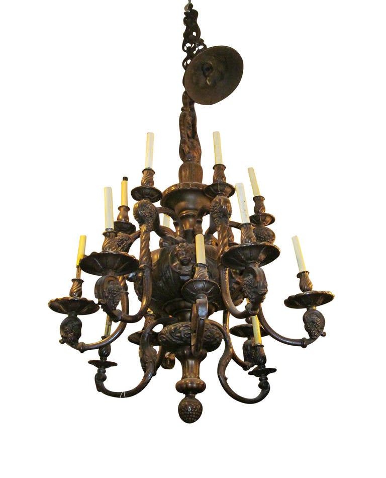 1890s heavy cast brass eighteen-arm chandelier with cherubs and scrolled arms with grape bunch accents. Price includes rewiring. This can be seen at our 400 Gilligan St location in Scranton, PA.