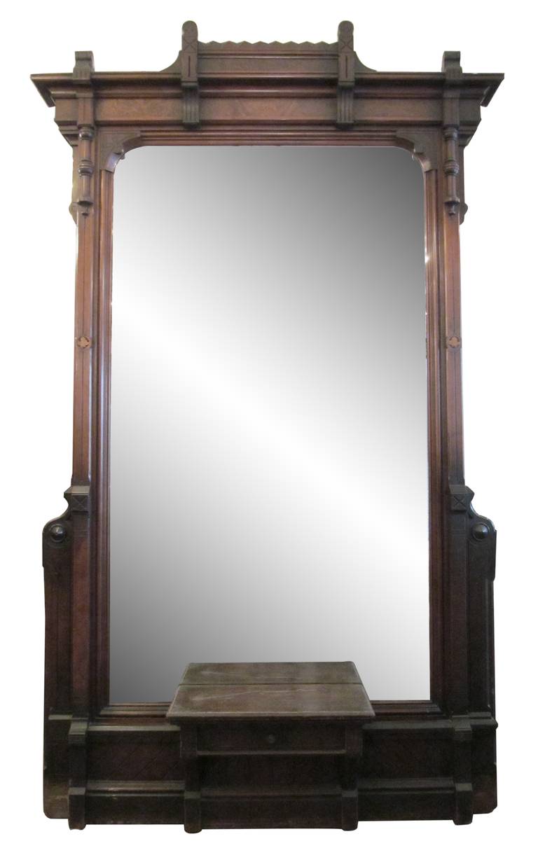 This oversized wall mirror once graced the entry foyer or hall of an Eastlake dwelling. Shelf has a small drawer underneath. This item can be seen at our 124 West 24th Street, New York location.