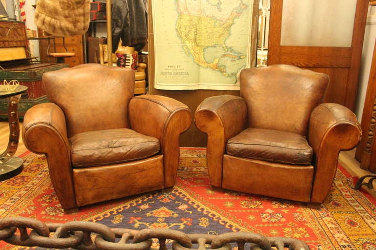 Pair of 1930s French club chairs with rare mustache style backs and exaggerated rolled arms. These can be seen at our 149 Madison Ave. Location in Manhattan.
  