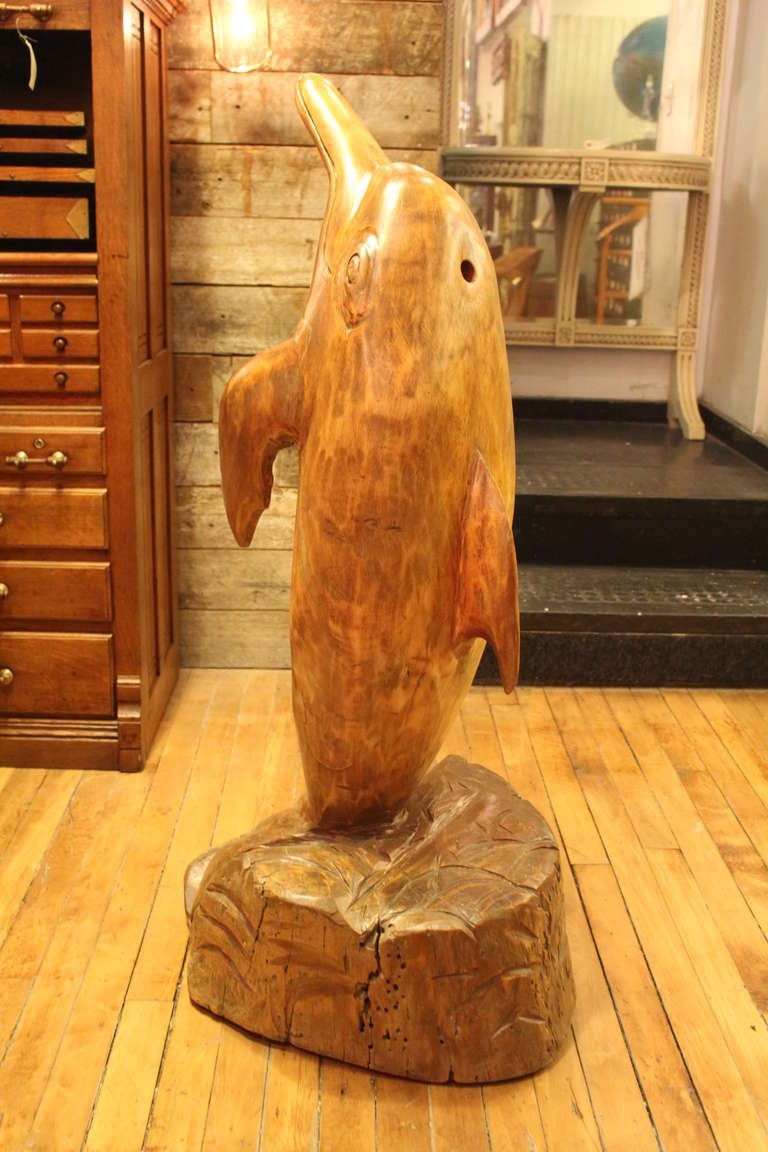 This interesting dolphin sculpture displays remarkable craftsmanship, carved from one piece of wood. This can be seen at our 1800 South Grand Avenue location in Los Angeles, CA