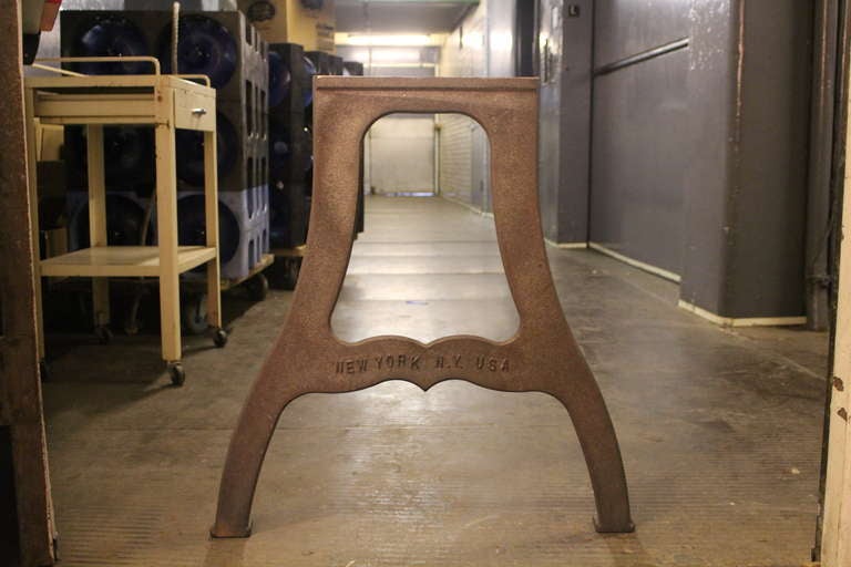 Pair of ductile iron industrial table legs with raised New York NY USA lettering. This can be viewed at one of our New York City locations. Please inquire for the exact address.