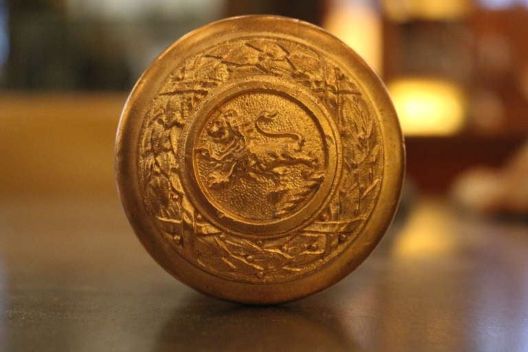 This standing lion and wreath knob is from the late 19th century. With intricate detail. Price is for one knob with matching rosette. Please inquire for multiples.
