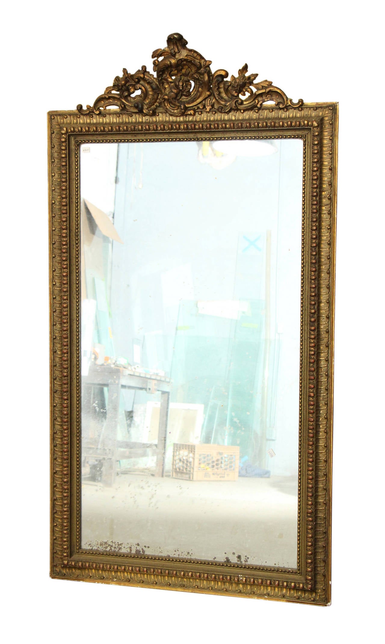 1890s French mirror Louis XV style. The mirror shows nice distressing. The frame is in overall good condition showing minor chips and wear, all age appropriate. This item can be viewed at our 149 Madison Ave location in Manhattan.