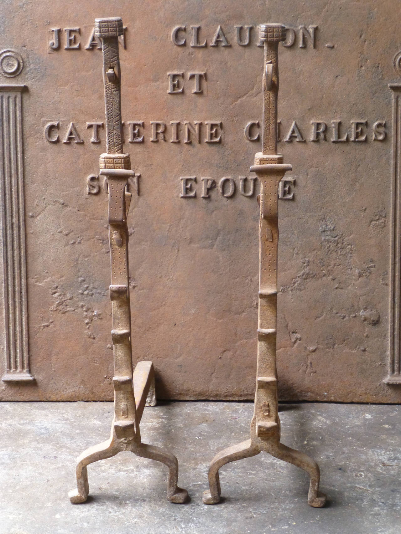 Gothic firedogs with spit hooks. These French andirons are called 'landiers' in France. This dates from the times the andirons were the main cooking equipment in the house. They had spit hooks to grill meat or poultry and sometimes a cup to keep