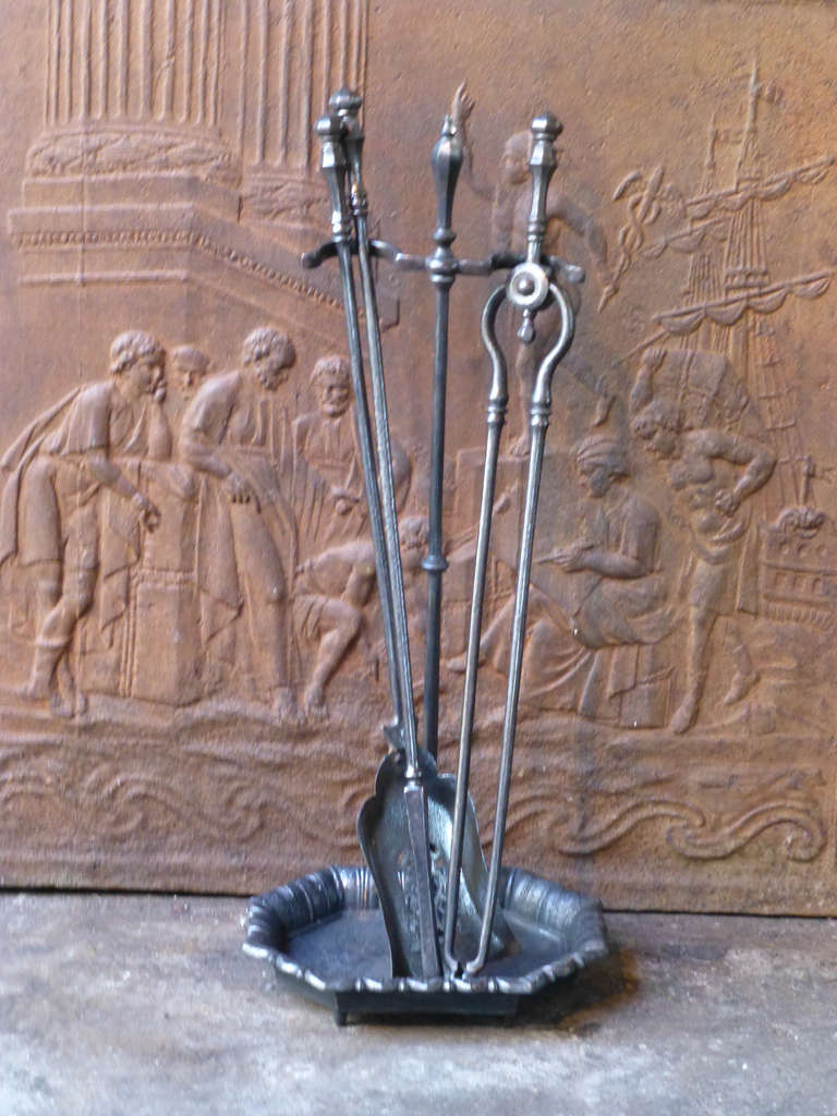Beautifully crafted English wrought iron fire tool set and stand.