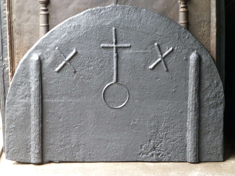 16th century Gothic fireback. From the early days of casting iron. The crosses and the orb are made by pressing cords in the original sand bed at the time of casting of the fireback.
