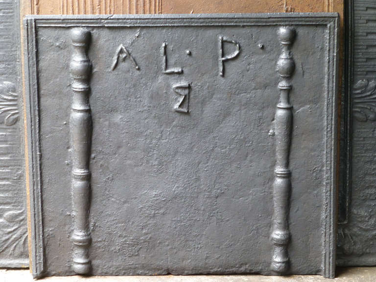 18th century French fireback with the initials of initial owner. The pillar refers to the club of Hercules, his favorite weapon. It symbolizes power. Since antiquity the ‘Pillars of Hercules’ are also the name of the promontories at both sides of