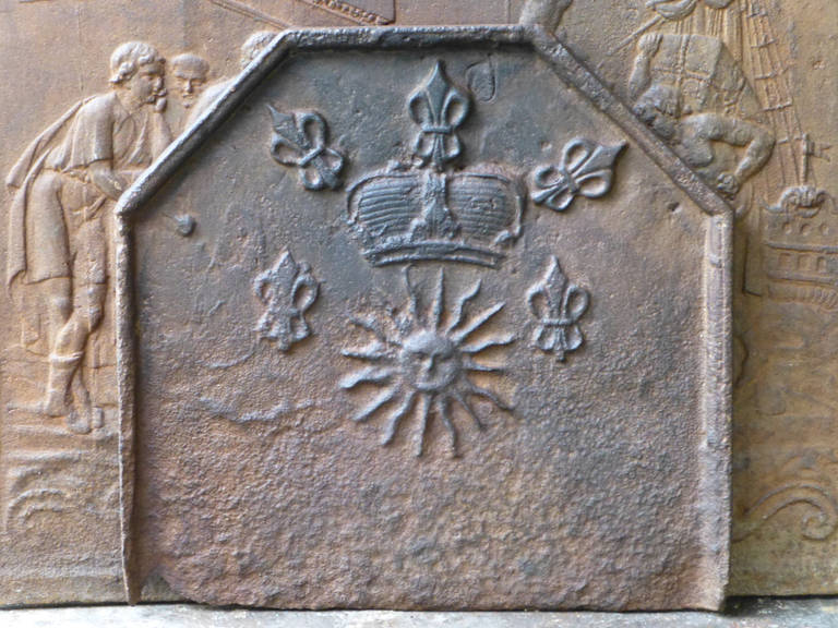 17th - 18th century French fireback with fleurs de lys and the sun, symbolizing Louis XIV, the Sun King.