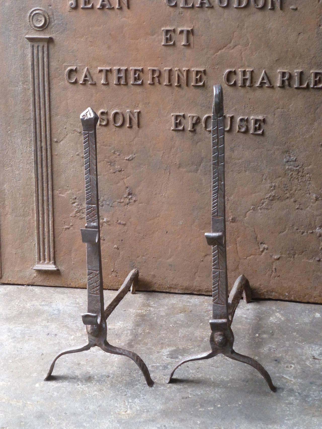 A so called 'paire de marriage' (wedding pair) whereby both families would order 1 andirons from the same blacksmith to for a couple for the new family hearth. Beautifully wrought iron with spit hooks.