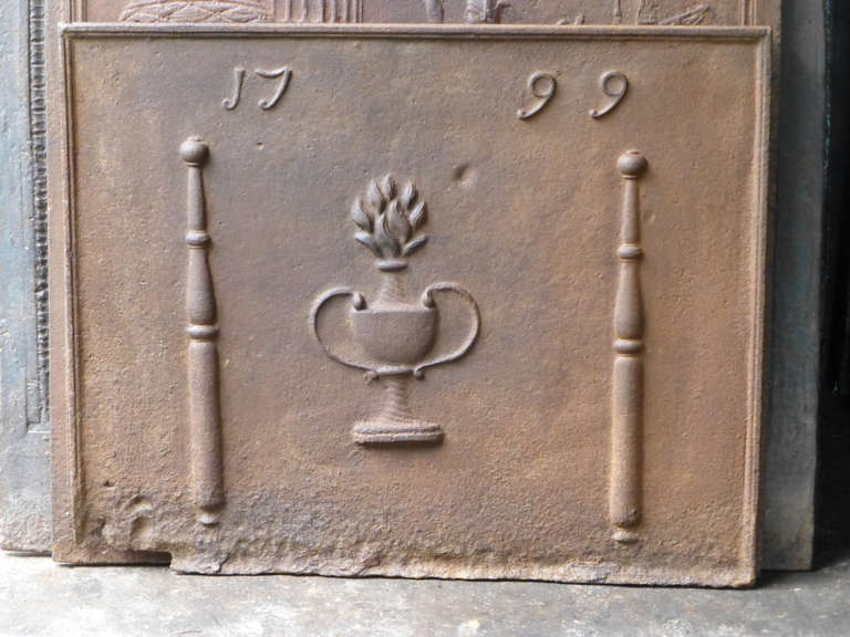 18th century French fireback with pillars, a flower basket and the date of production 1799.