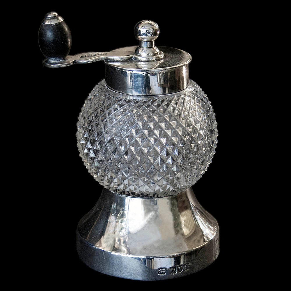 A nice example of an Edwardian silver mounted,glass bodied pepper mill with a Peugeot Freres mechanism. The silver hallmarked on finial,handle, collar and base.The base engraved with the initials BR