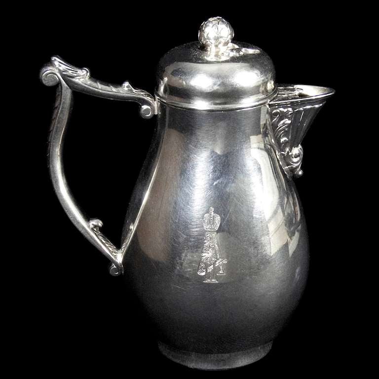 A very good silver chocolate pot with removable lid with a finial in the form of a globe artichoke. The handle capped with a shell thumb piece and the spout embellished with acanthus leaf decoration.  

Provenance: The Crown on the chocolate pot