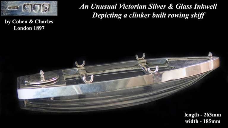 A very unusual Victorian silver and glass inkwell beautifully depicting a clinker built rowing skiff with the rollocks as pen holders and stamp box at bow and inkwell at stern

Artists/Makers/Schools: Cohen & Charles, London (1890-1958)
A very