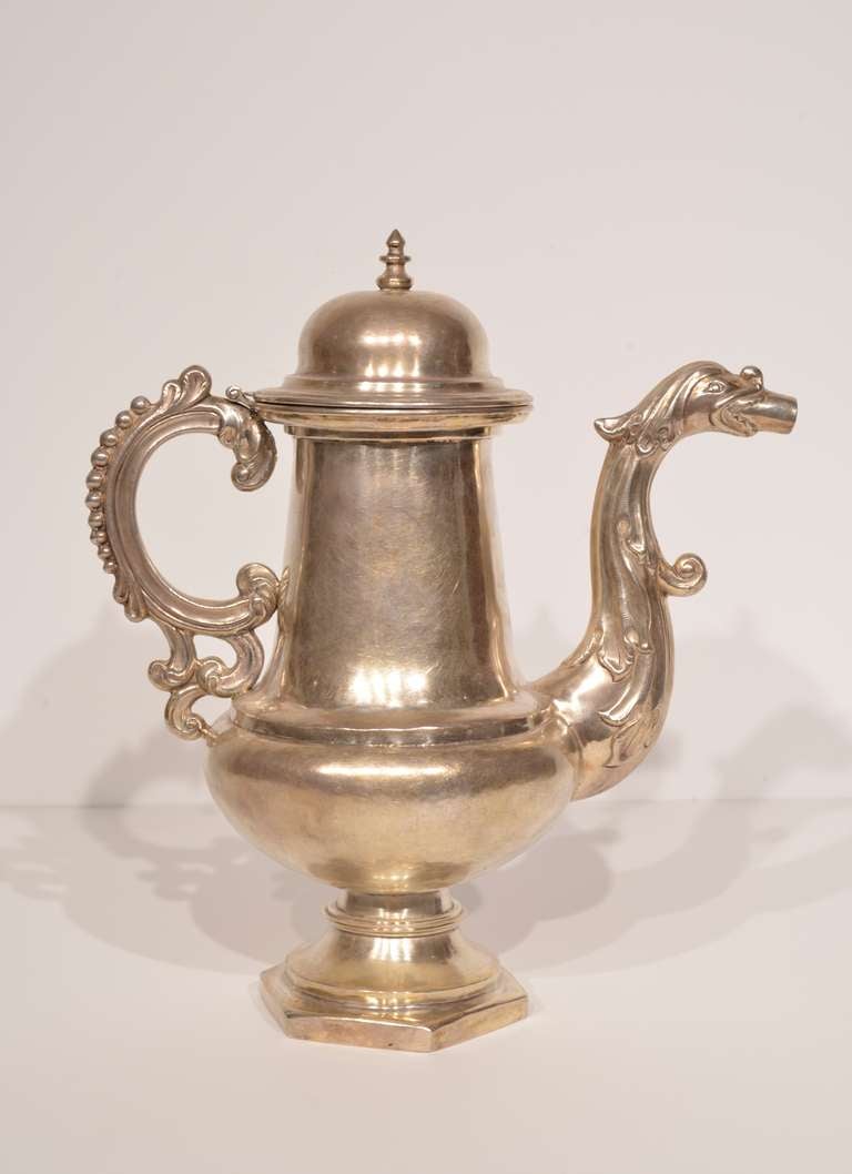 Fine silver cafetera from Potosi, Bolivia. This piece dates to 1750 and features a domed, hinged top and a c-shaped handle with ridged flourishes. The spout is fashioned into the shape of a dragon or serpent, with curled embellishments on its head