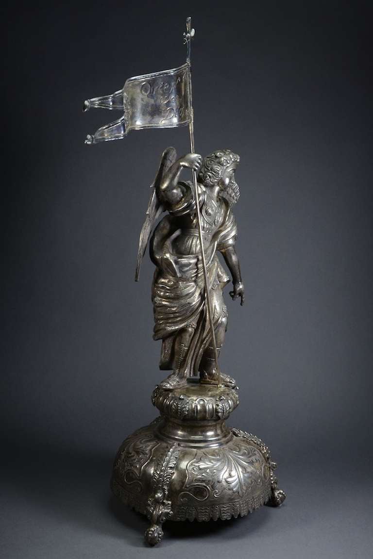 This wonderfully detailed silver figure of the Archangel Michael stands just over 2 feet tall. The Archangel Michael (or simply St. Michael) is often called the avenging angel; as such, he was considered the Captain of the Holy Angels, the defender