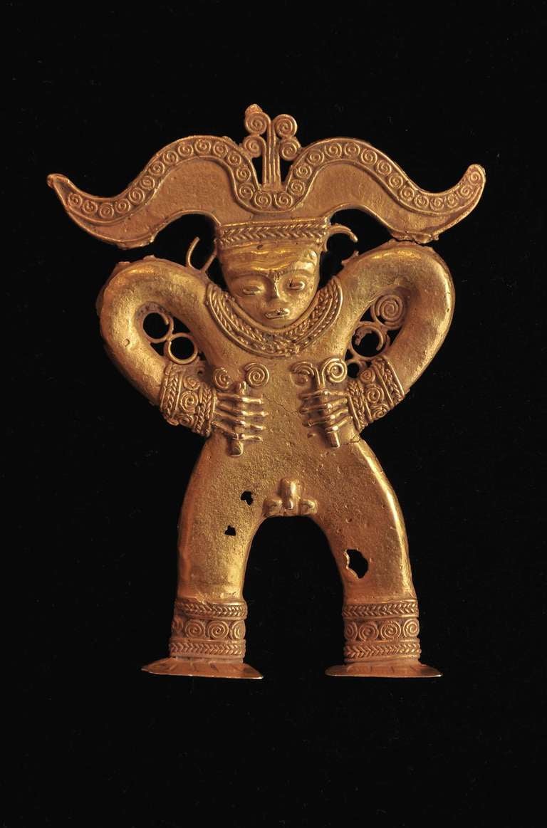 This figure comes from the Quimbaya-Urabá culture of Columbia and Panama. The figure represents a very important dignitary, which can be inferred by the multiple pieces of jewelry he is wearing, particularly evidenced in the elaborate headdress and