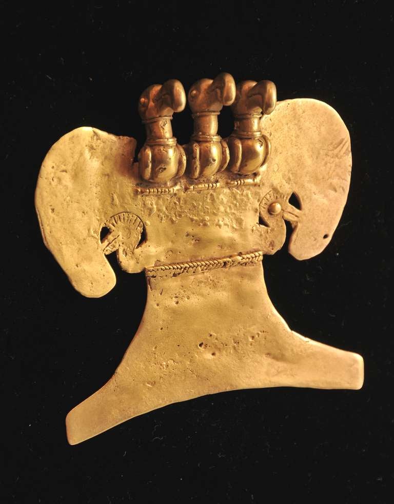 This gorgeously detailed pendant comes from the pre-Columbian Tairona culture. The pendant probably represents a Harpy Eagle (the largest on the American continent), and the triple head is probably meant to emphasize power, importance, and mythical
