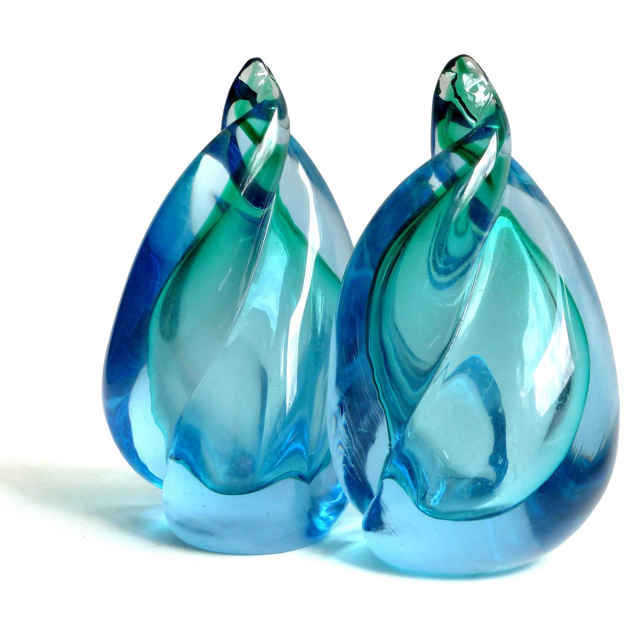 FREE Shipping Worldwide! See details below description.

Wonderful Murano Hand Blown Blue over Green Sommerso Art Glass Bookends in Twisting Flame Design. Documented to designer Alfredo Barbini, circa 1950-1960, and published in his catalog. Great