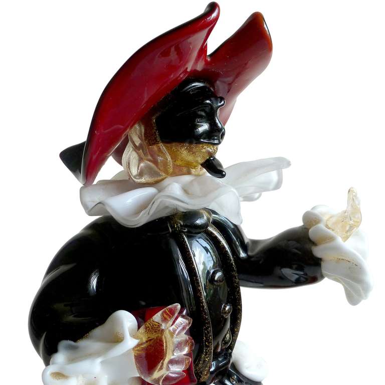 FREE Shipping Worldwide! See details below description.

Wonderful Murano Hand Blown Black, Red, White and Gold Flecks Art Glass Royal Court Poet or Orator Holding a Book. Attributed to designer Alfredo Barbini, circa 1950s. The sculpture is