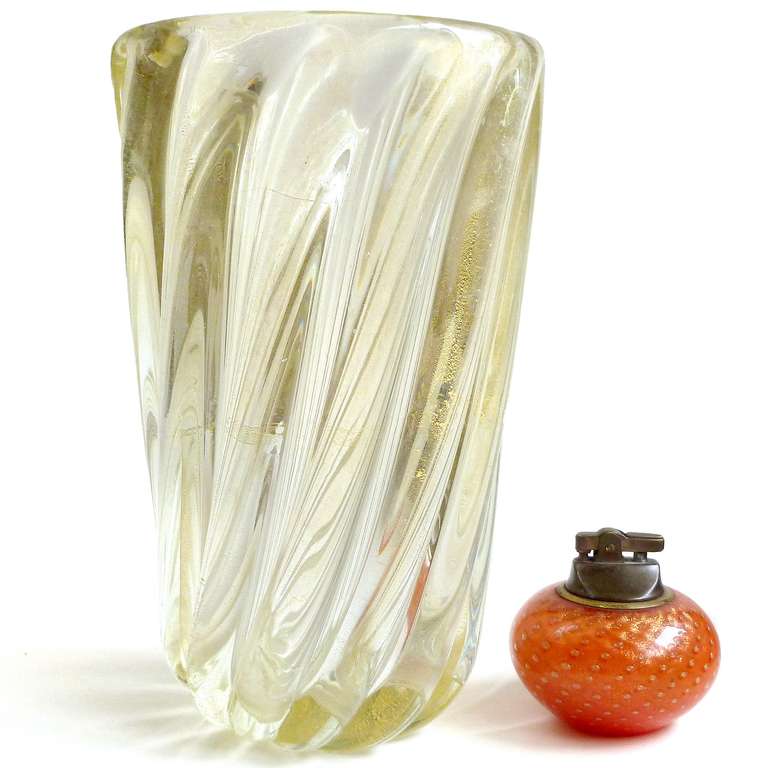 Free Shipping Worldwide! See details below description.

Large Murano Hand Blown Gold Flecks Art Glass Ribbed Flower Vase. Documented to designer Archimede Seguso. The piece is very thick and heavy, with a chip on the side (see photo 6). Turn it