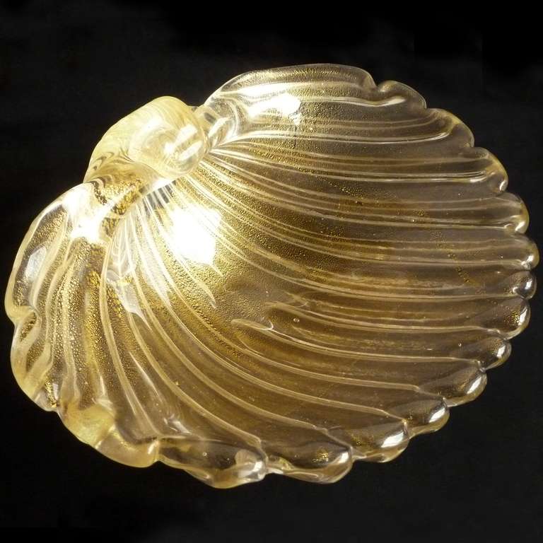 Large Murano hand blown gold flecks Italian art glass conch shell centerpiece bowl. Attributed to designer Archimede Seguso. The piece is profusely covered in gold leaf, 11" across, with a real natural look. Would make a great statement at a